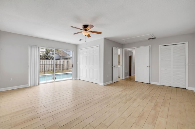 6 Cimmaron Dr, Palm Coast, FL 32137 - unfurnished living room featuring attic access, ceiling fan, baseboards, and light wood-type flooring