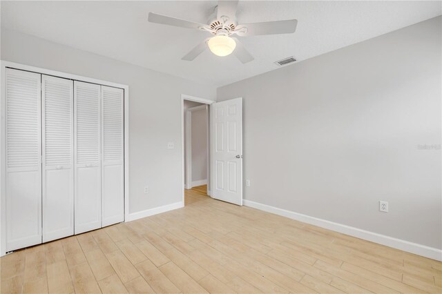 6 Cimmaron Dr, Palm Coast, FL 32137 - unfurnished bedroom featuring baseboards, a closet, light wood-type flooring, and ceiling fan