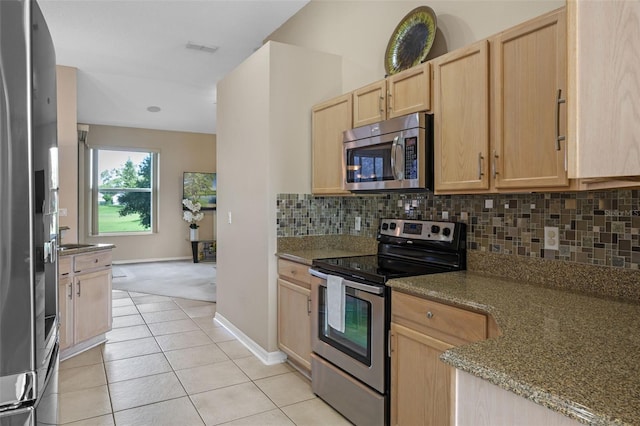 2710 Autumn Ln, Eustis, FL 32726 - kitchen featuring appliances with stainless steel finishes, light brown cabinets, decorative backsplash, baseboards, and light tile patterned floors
