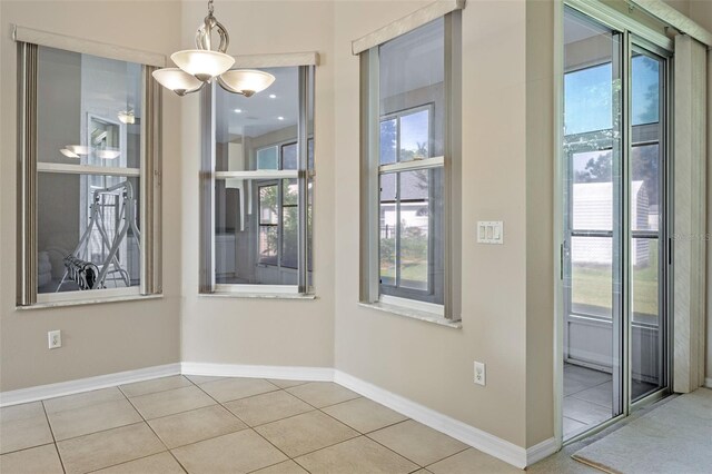 2710 Autumn Ln, Eustis, FL 32726 - unfurnished dining area with plenty of natural light, tile patterned floors, and baseboards