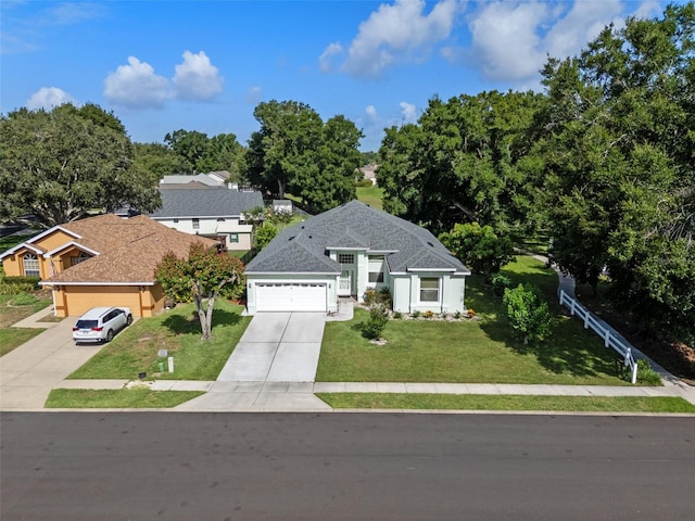 2710 Autumn Ln, Eustis, FL 32726 - view of front of house featuring driveway, a front lawn, and a garage