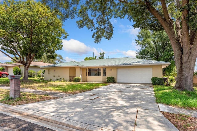 611 Lakespur Ln, Altamonte Springs, FL 32714 - single story home with stucco siding, an attached garage, concrete driveway, a front yard, and metal roof
