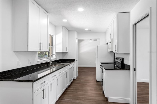 611 Lakespur Ln, Altamonte Springs, FL 32714 - kitchen with white appliances, a sink, a textured ceiling, white cabinets, and baseboards
