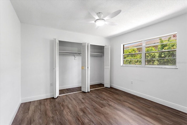 611 Lakespur Ln, Altamonte Springs, FL 32714 - unfurnished bedroom with wood finished floors, multiple closets, baseboards, a ceiling fan, and a textured ceiling