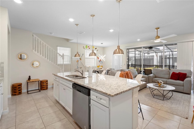 4314 Lana Ave, Davenport, FL 33897 - kitchen with stainless steel dishwasher, a sink, ceiling fan, light tile patterned floors, and a center island with sink