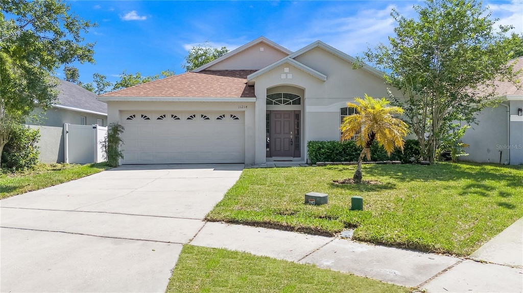 11218 Rouse Run Cir, Orlando, FL 32817 - single story home with stucco siding, an attached garage, concrete driveway, and a shingled roof