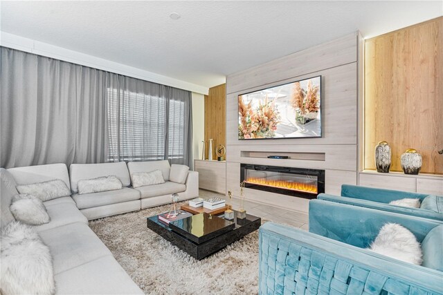8833 Cruden Bay Ct, Davenport, FL 33896 - living area with a glass covered fireplace and wood walls