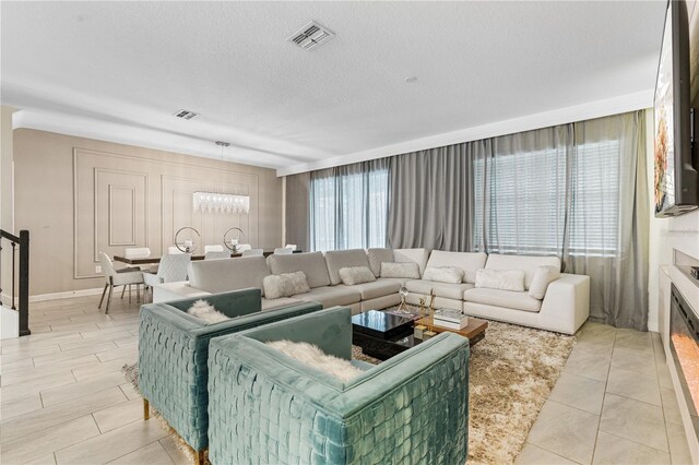 8833 Cruden Bay Ct, Davenport, FL 33896 - living room featuring stairs and a textured ceiling