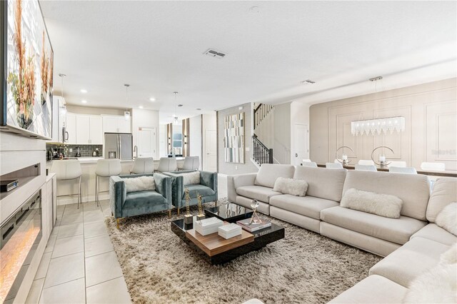 8833 Cruden Bay Ct, Davenport, FL 33896 - living room with light tile patterned floors, stairway, and recessed lighting