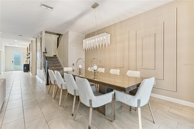 8833 Cruden Bay Ct, Davenport, FL 33896 - dining space with stairs, baseboards, and a chandelier