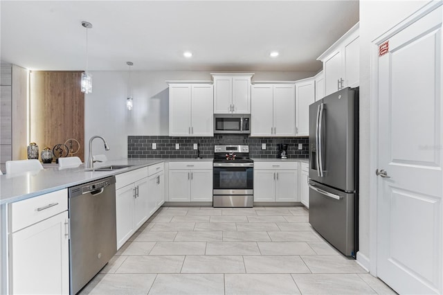 8833 Cruden Bay Ct, Davenport, FL 33896 - kitchen featuring stainless steel appliances, a sink, a peninsula, tasteful backsplash, and light countertops