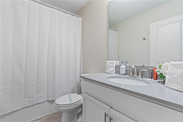8833 Cruden Bay Ct, Davenport, FL 33896 - bathroom featuring vanity, toilet, tile patterned floors, and shower / bath combination with curtain