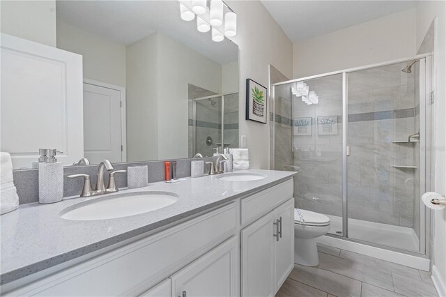 8833 Cruden Bay Ct, Davenport, FL 33896 - full bath featuring double vanity, toilet, a stall shower, and tile patterned flooring