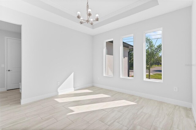 304 N Jungle Rd, Geneva, FL 32732 - unfurnished room featuring a chandelier, a tray ceiling, baseboards, and ornamental molding