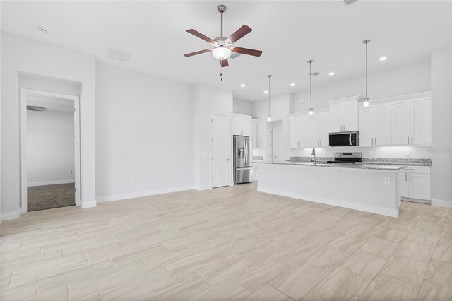 304 N Jungle Rd, Geneva, FL 32732 - kitchen featuring stainless steel appliances, a ceiling fan, a sink, white cabinetry, and open floor plan
