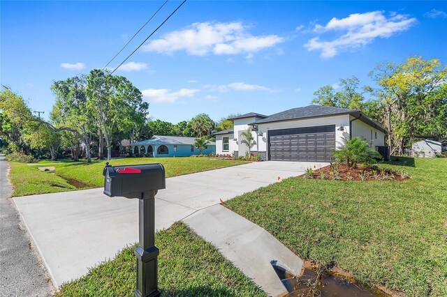 304 N Jungle Rd, Geneva, FL 32732 - view of front of property featuring stucco siding, a front lawn, concrete driveway, an attached garage, and cooling unit