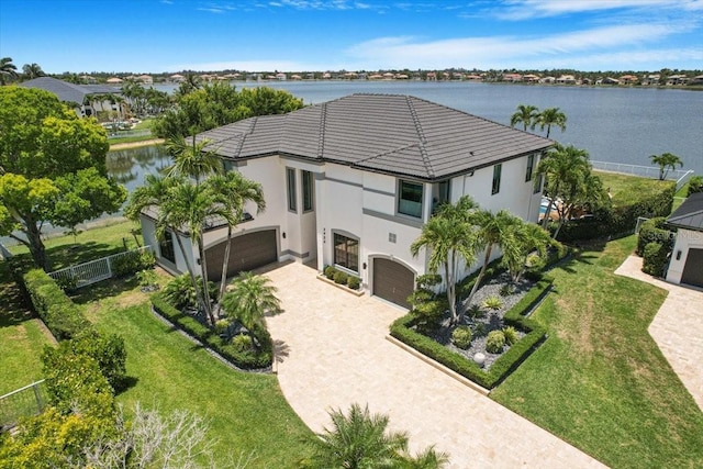 3924 SW 189th Ave, Miramar, FL 33029 - view of front of house with an attached garage, stucco siding, driveway, a water view, and a tile roof