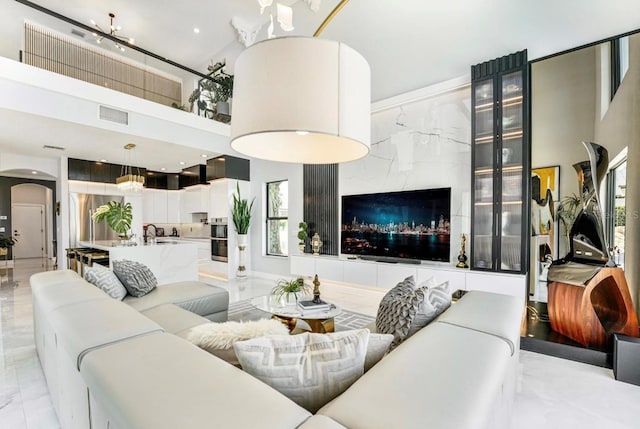 3924 SW 189th Ave, Miramar, FL 33029 - living room featuring light marble finish floors, arched walkways, and a towering ceiling