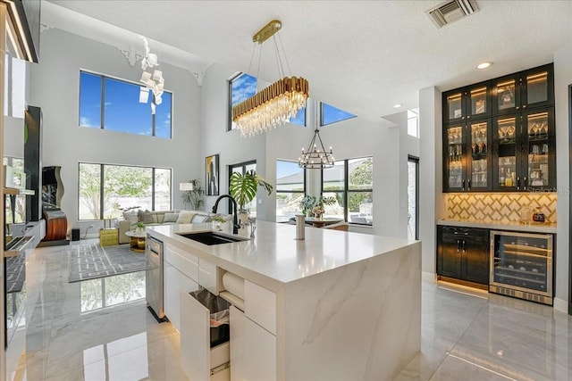 3924 SW 189th Ave, Miramar, FL 33029 - kitchen with wine cooler, a chandelier, a sink, light marble finish floors, and recessed lighting