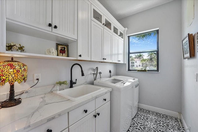 3924 SW 189th Ave, Miramar, FL 33029 - clothes washing area with washer and clothes dryer, cabinet space, baseboards, and light tile patterned floors