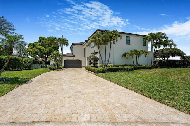 3924 SW 189th Ave, Miramar, FL 33029 - mediterranean / spanish house featuring decorative driveway, an attached garage, a front yard, and stucco siding