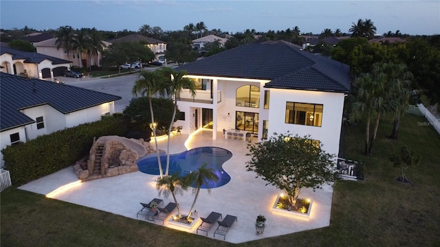 3924 SW 189th Ave, Miramar, FL 33029 - rear view of property featuring a balcony, a fire pit, a patio, an outdoor pool, and stucco siding