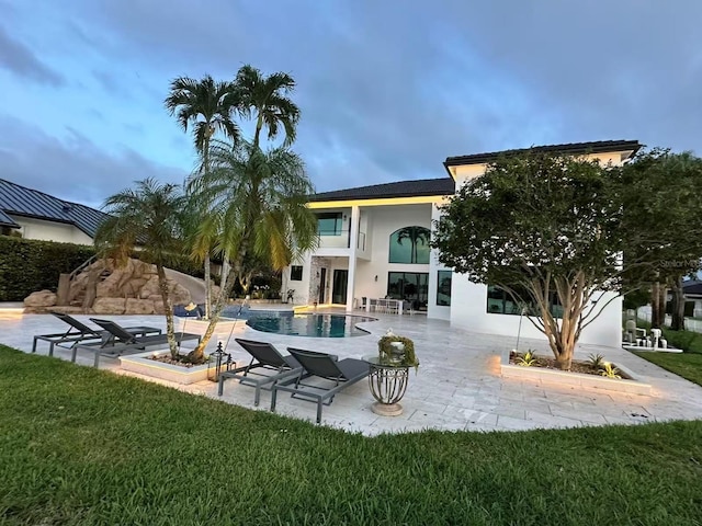 3924 SW 189th Ave, Miramar, FL 33029 - rear view of property featuring a patio area, a lawn, an outdoor pool, and stucco siding