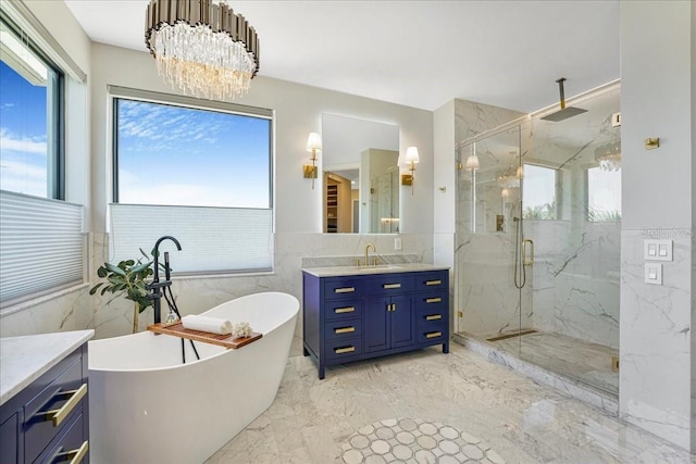 3924 SW 189th Ave, Miramar, FL 33029 - bathroom featuring tile walls, marble tiled floors, vanity, a marble finish shower, and a freestanding bath