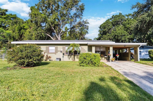 3118 Walnut St, Winter Haven, FL 33881 - ranch-style house featuring an attached carport, a front lawn, and concrete driveway