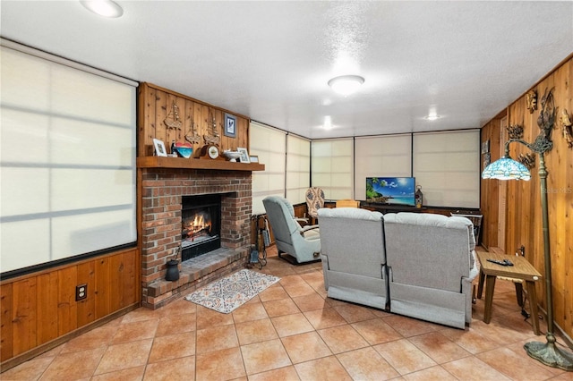 3118 Walnut St, Winter Haven, FL 33881 - living room featuring light tile patterned floors, a fireplace, wooden walls, and a textured ceiling