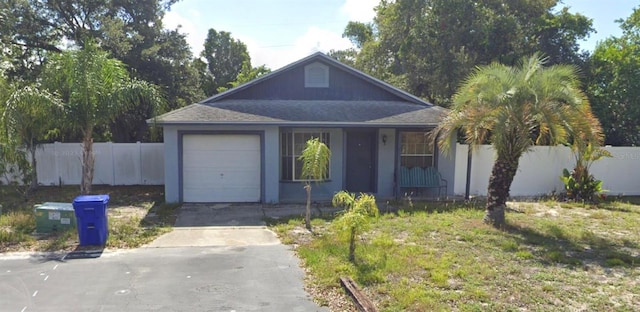 3607 Johnson Ct, Palm Harbor, FL 34684 - view of front of property featuring fence, concrete driveway, a garage, and a shingled roof