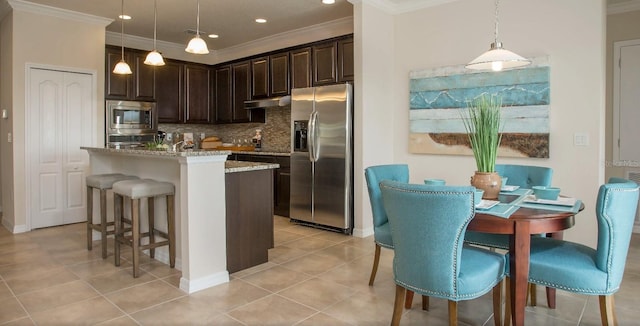 6 Fringetree Ct, Homosassa, FL 34446 - kitchen with appliances with stainless steel finishes, dark brown cabinets, a breakfast bar area, backsplash, and crown molding