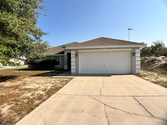 single story home with stucco siding, concrete driveway, and an attached garage