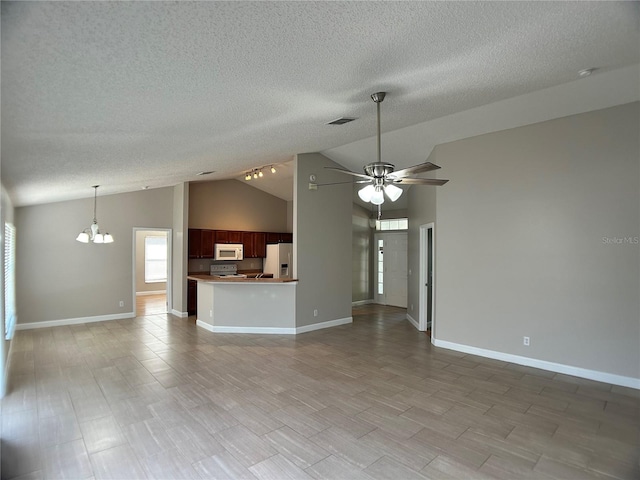 unfurnished living room featuring a chandelier, a ceiling fan, a textured ceiling, baseboards, and high vaulted ceiling