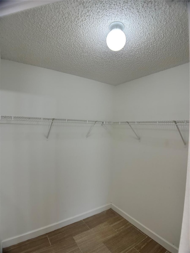 walk in closet featuring dark wood-type flooring