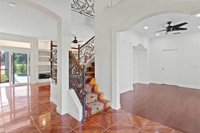 1254 Shelter Rock Rd, Orlando, FL 32835 - stairway featuring ceiling fan, arched walkways, ornamental molding, recessed lighting, and built in features