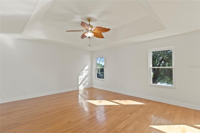1254 Shelter Rock Rd, Orlando, FL 32835 - unfurnished room with a tray ceiling, a ceiling fan, and light wood-style flooring