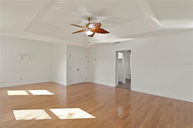 1254 Shelter Rock Rd, Orlando, FL 32835 - unfurnished room with a tray ceiling, light wood finished floors, and ceiling fan