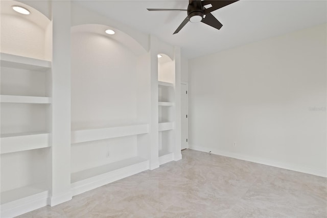 1254 Shelter Rock Rd, Orlando, FL 32835 - empty room with built in shelves, a ceiling fan, and arched walkways
