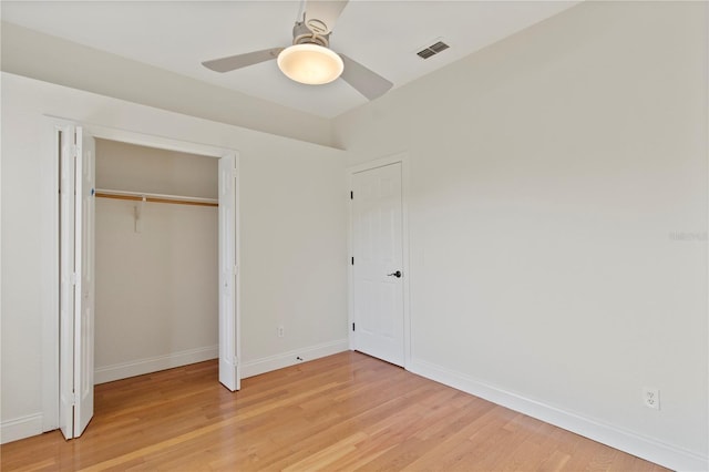1254 Shelter Rock Rd, Orlando, FL 32835 - unfurnished bedroom featuring light wood-style flooring, ceiling fan, and a closet