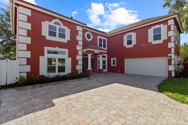 1254 Shelter Rock Rd, Orlando, FL 32835 - view of front of property with an attached garage, stucco siding, and decorative driveway