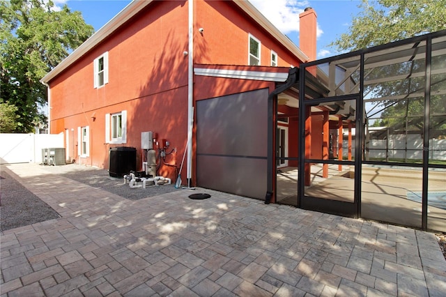 1254 Shelter Rock Rd, Orlando, FL 32835 - back of property featuring a patio area, a gate, a lanai, and a chimney