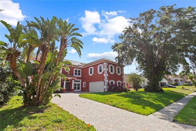 1254 Shelter Rock Rd, Orlando, FL 32835 - view of property featuring a garage, a front lawn, driveway, and roof mounted solar panels