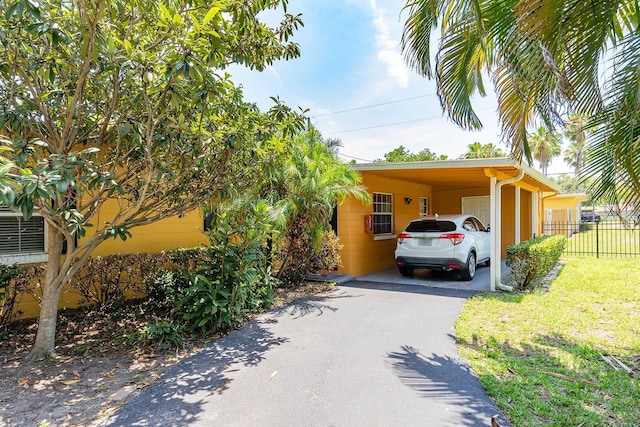 2272 Raeford Rd Unit A-3, Orlando, FL 32806 - view of front facade with asphalt driveway and a carport