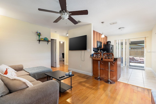 2272 Raeford Rd Unit A-3, Orlando, FL 32806 - living area featuring a ceiling fan, light wood-style flooring, and baseboards