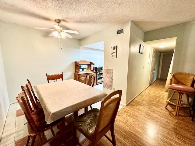 912 Lake Destiny Rd Unit F, Altamonte Springs, FL 32714 - dining area featuring a ceiling fan, a textured ceiling, and light wood finished floors