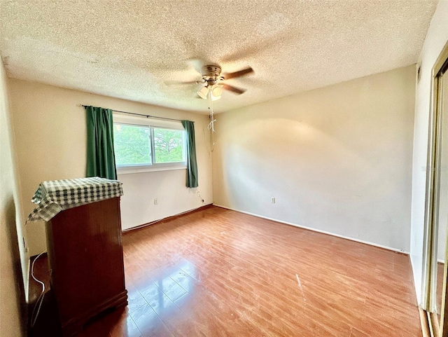 912 Lake Destiny Rd Unit F, Altamonte Springs, FL 32714 - spare room featuring ceiling fan, wood finished floors, a textured ceiling, and baseboards