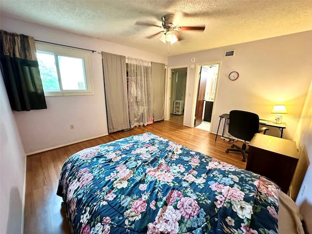 912 Lake Destiny Rd Unit F, Altamonte Springs, FL 32714 - bedroom featuring a textured ceiling, wood finished floors, and a ceiling fan