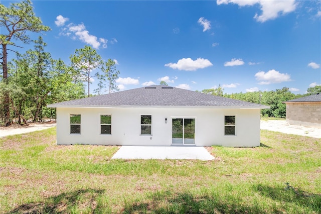 7229 N Gibralter Dr, Citrus Springs, FL 34434 - rear view of house featuring a patio area, stucco siding, a lawn, and roof with shingles