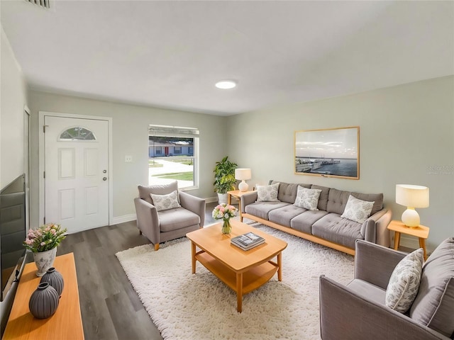 living room featuring wood finished floors and baseboards